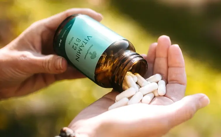 Ručník s kapslemi vitamínu B12 z lahvičky venku.